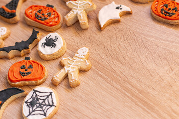 Halloween gingerbread cookies on light wood background. Bright homemade cookies for Halloween party