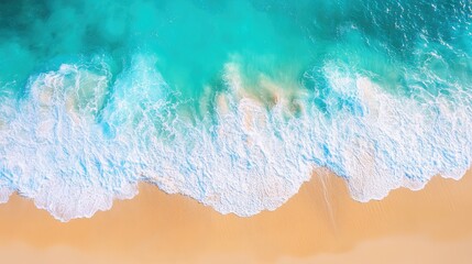 Fototapeta premium Sunny aerial view of turquoise water with waves splashing and a bright, sandy beach stretching out from the top view