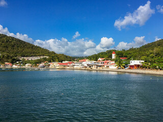 Obraz premium Deshaies waterfront under late afternoon sun, this quaint village is the main filming location of TV series 