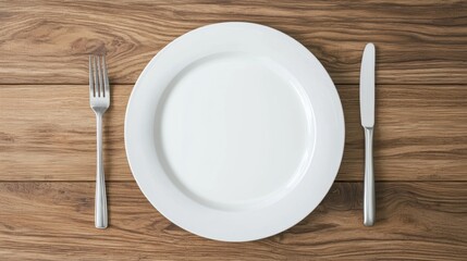 Empty plate with fork and knife, wood background