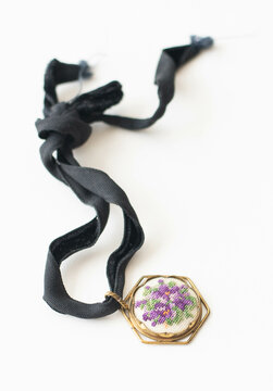 Antique pendant with embroidered pansy flower