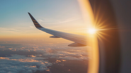 Naklejka premium traveler looking out from a plane window at sunrise photo
