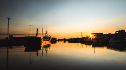 Calm and quiet shipyard with water reflections on a sunset, Brighton and Hove, East Sussex, UK