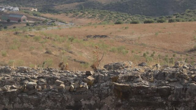 Rests of a wall of a fortress at sunset, Alcaucin, Spain