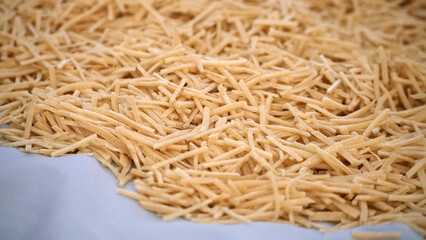 Cutting noodles from homemade natural wheat flour dough,