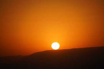 The solar disk over the Jordanian mountains