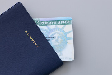 United States passport, permanent resident card (green card)  on desk . Immigration concept	