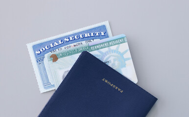 United States passport, social security card and permanent resident (green) card on white background. Immigration concept	