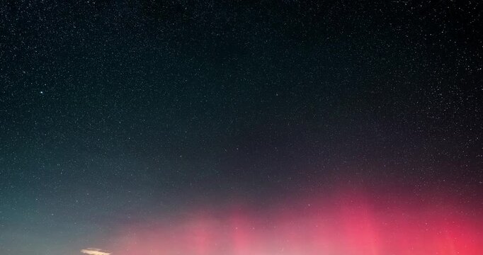 Dark starry night sky with stars and red aurora borealis in Astronomy background Time lapse
