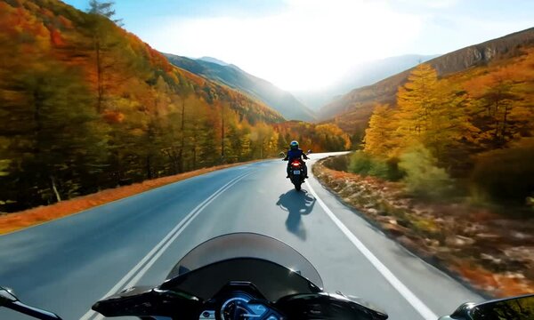 riding a motorcycle on the open road in the autumn season