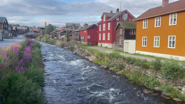 Old wooden houses along the river in R&oslash;ros mining town, Norway.