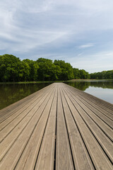 Wooden pier on the lake, symmetrical shot, leading lines made of planks.