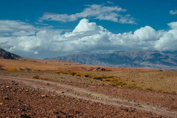 Mountain valley with dirt road in autumn