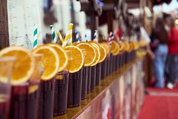 Row of Refreshing Sangria Drinks with Orange Garnish at Outdoor Market