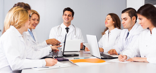 Doctors in negotiations in conference room