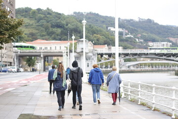 People walking by the riverside of Bilbao