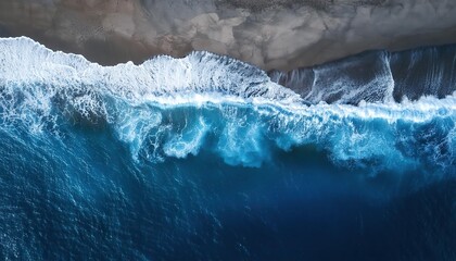 ocean waves and foam splashing on the dark navy blue or gray sand beach