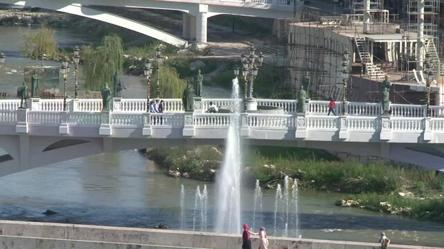 Bridges of Skopje city center as people walking on them 