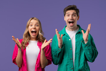 Surprised happy couple expresses WOW, OMG. Impressed man woman. Great, unbelievable news