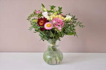 A beautiful bouquet stands in a vase. A floral compliment.