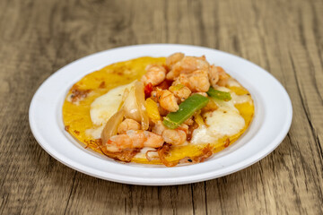 Grilled shirmp taco gobernador covered with onion, cilantro, and cheese served on a tortilla for lunch