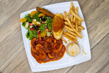 Overhead view of grilled spicy shrimp diablo served with french fries, toast, and rice for a delicious Mexican seafood dinner