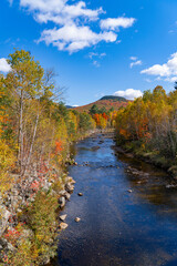 landscape of colorful autumn mountain forest and river