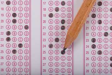 Exam, a hand taking an exam with a pen on an optical reader. Exam, an idea concept. Anxiety about...