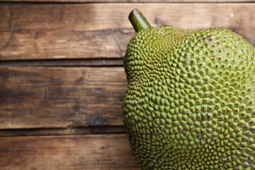 Fresh exotic jackfruit on wooden table, above view. Space for text