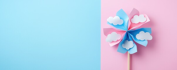 Fototapeta premium Cute blue and pink paper pinwheel with white polka dots on a soft pastel pink background