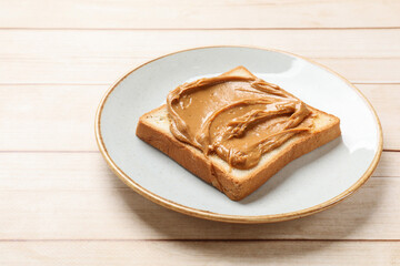 Delicious sandwich with peanut butter on white wooden table