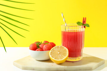 Tasty watermelon drink in glass and fresh fruits on white table