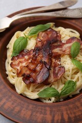 Delicious pasta Carbonara served on table, closeup