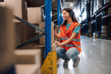 Warehouse worker scanning package using barcode scanner and headset