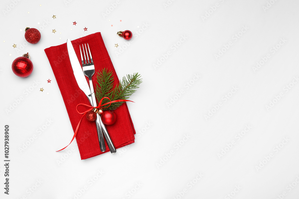 Wall mural Christmas table setting. Cutlery, napkin and festive decor on white background, flat lay. Space for text