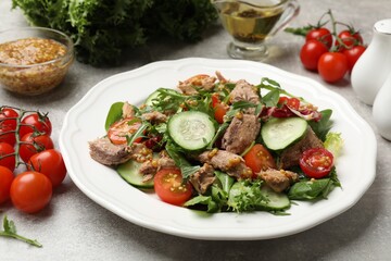 Delicious fresh tuna salad on grey table, closeup