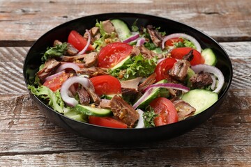 Delicious fresh tuna salad on wooden table, closeup