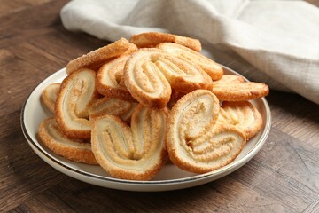 Tasty french palmier cookies on wooden table, closeup