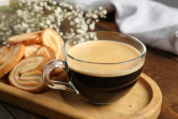 Tasty french palmier cookies and coffee on wooden table, closeup