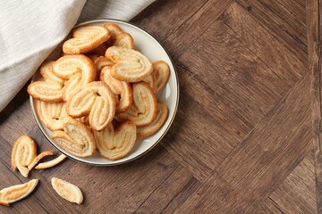 Tasty french palmier cookies on wooden table, top view. Space for text