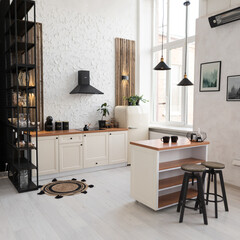 Bright and cozy modern kitchen with wooden accents, minimalistic decor, and large windows in a spacious apartment during daytime