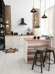 Modern kitchen design featuring minimalist decor and stylish furniture in a bright, airy space with wooden accents and contemporary lighting