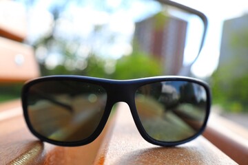 Black sunglasses on a wooden bench