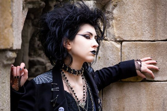 Portrait of Dark gothic fashion youg woman with black makeup, black lipstick and nose piercing.Italian beautiful brunette girl. Dark lady. Dark girl. Trad goth girl. Close-up photo