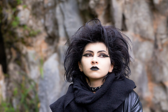 Portrait of Dark gothic fashion youg woman with black makeup, black lipstick and nose piercing. Italian beautiful brunette girl. Dark lady. Dark girl. Trad goth girl. Close-up photo