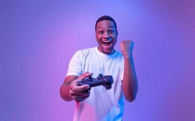 Video Gaming Concept. Euphoric African American Guy With Joystick Celebrating Game Win, Cheerful...