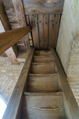 An old antique wooden staircase. An external staircase for the entrance to the bell tower of the old church.