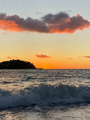 Sunset on the sea with a wave rolling in. Santa Ponsa. Mallorca Island. Spain
