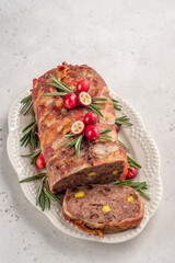 A large meatloaf with cranberries and rosemary