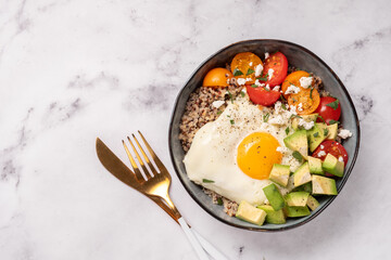 quinoa bowl with egg, avocado and tomato
